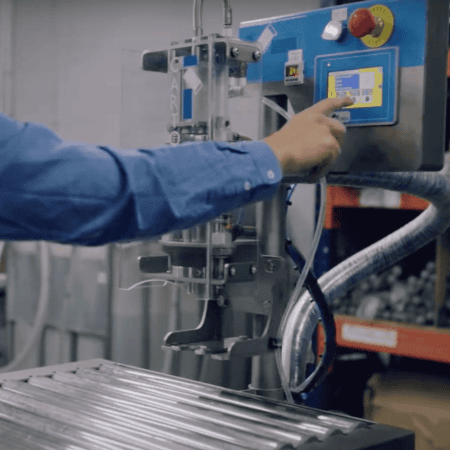 Ecofill bag in box machine with a hand controlling a touch screen