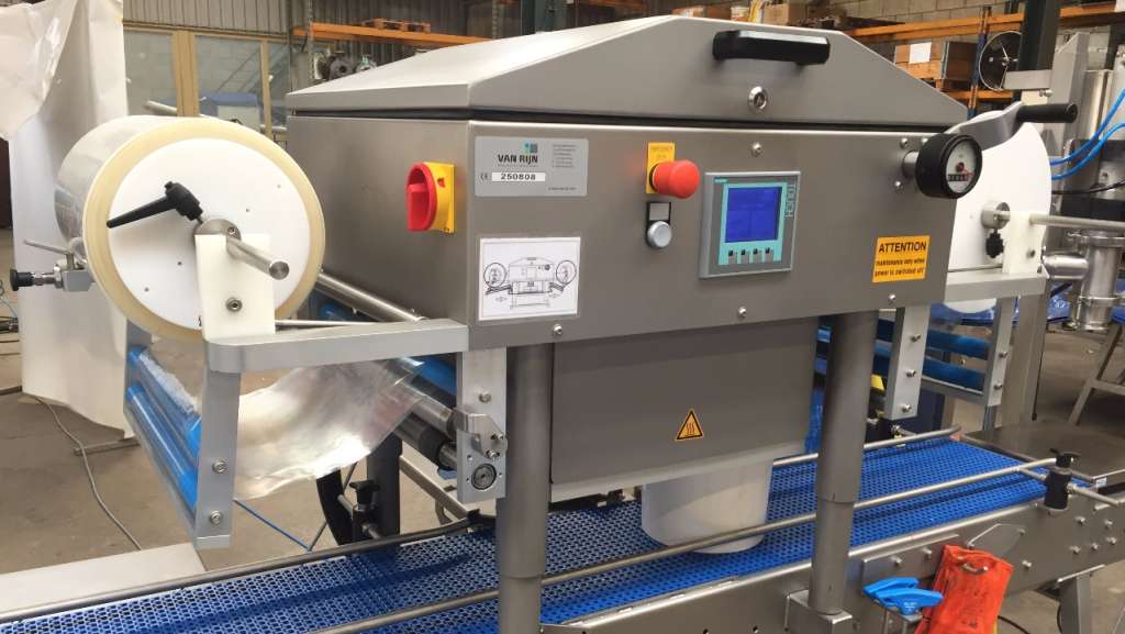 Bucket sealer machine being used in factory setting